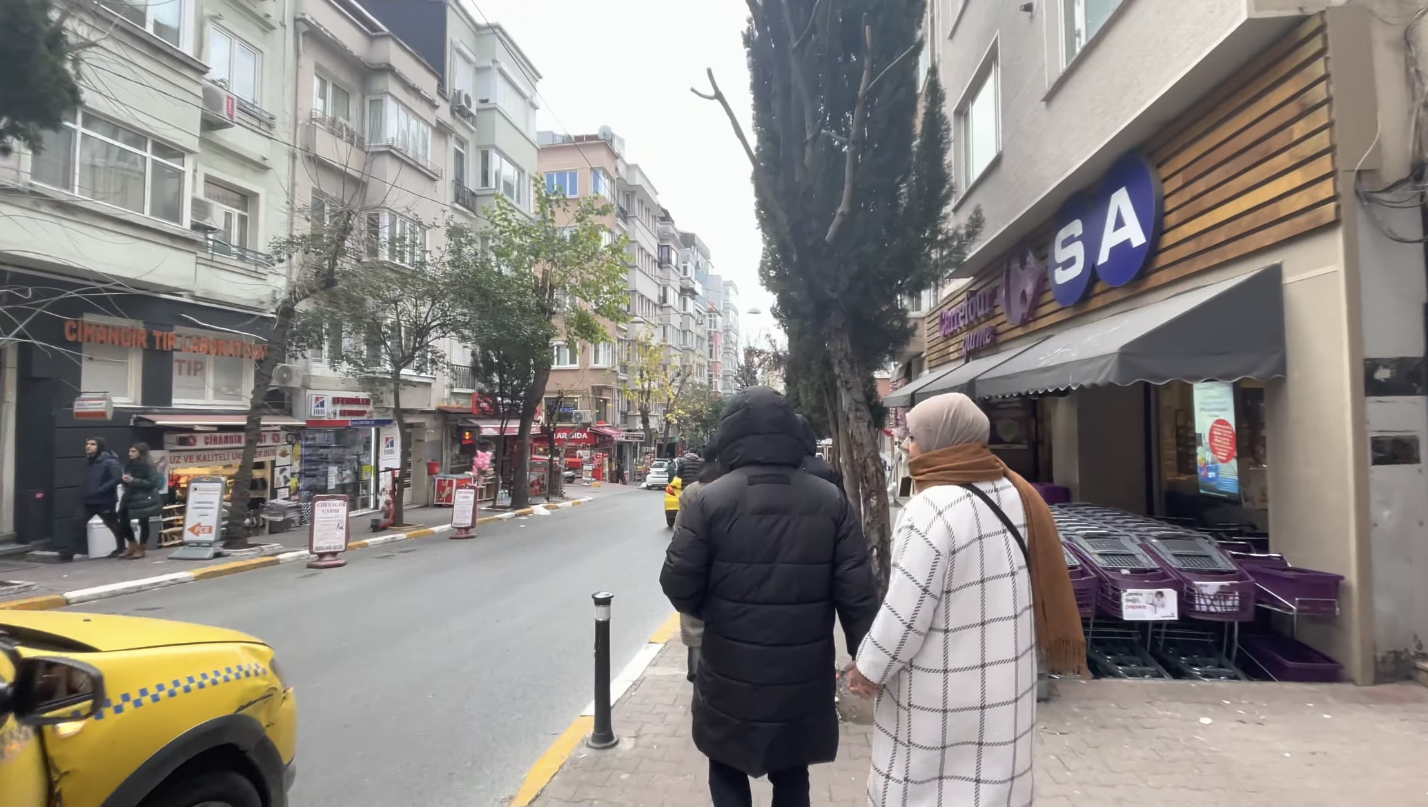 A couple walking the main street of Cihangir Neighborhood in the morning